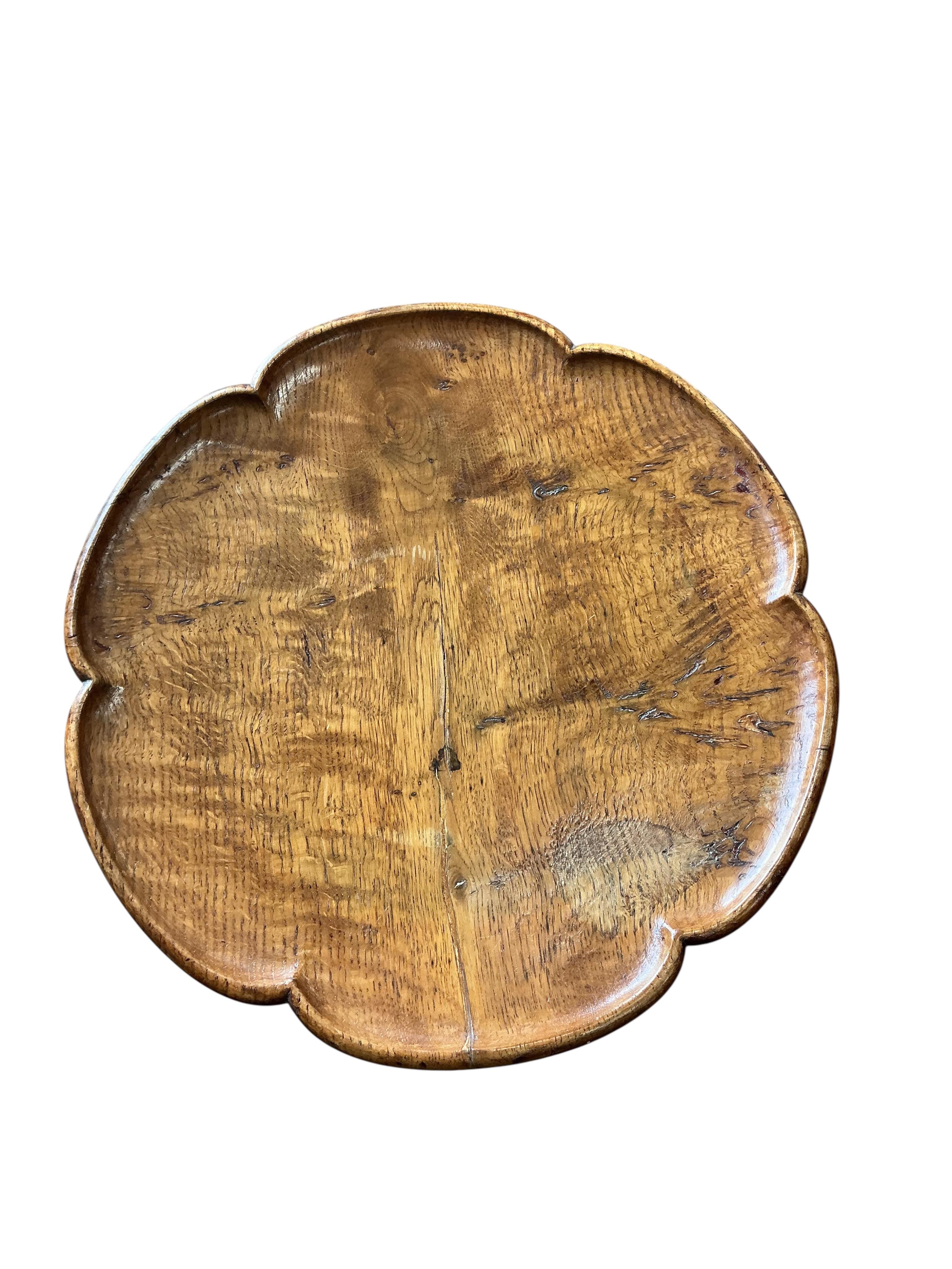 A Victorian circular elm tripod wine table, diameter 36cm, height 72cm